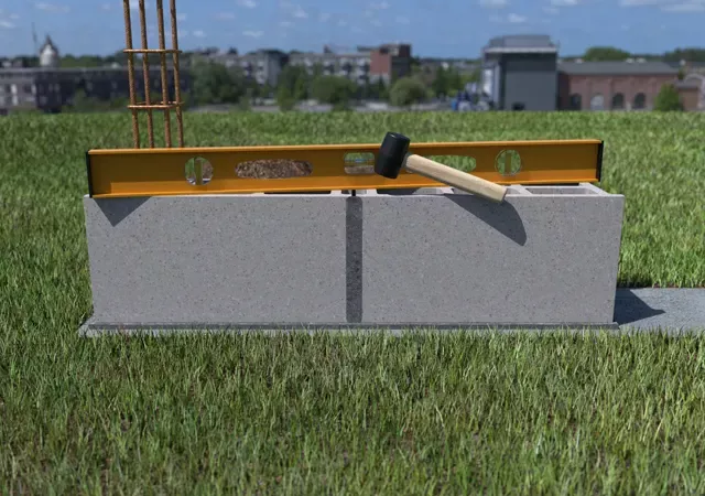 Construction d'un muret de clôture - Pose second parpaing et vérifier niveau